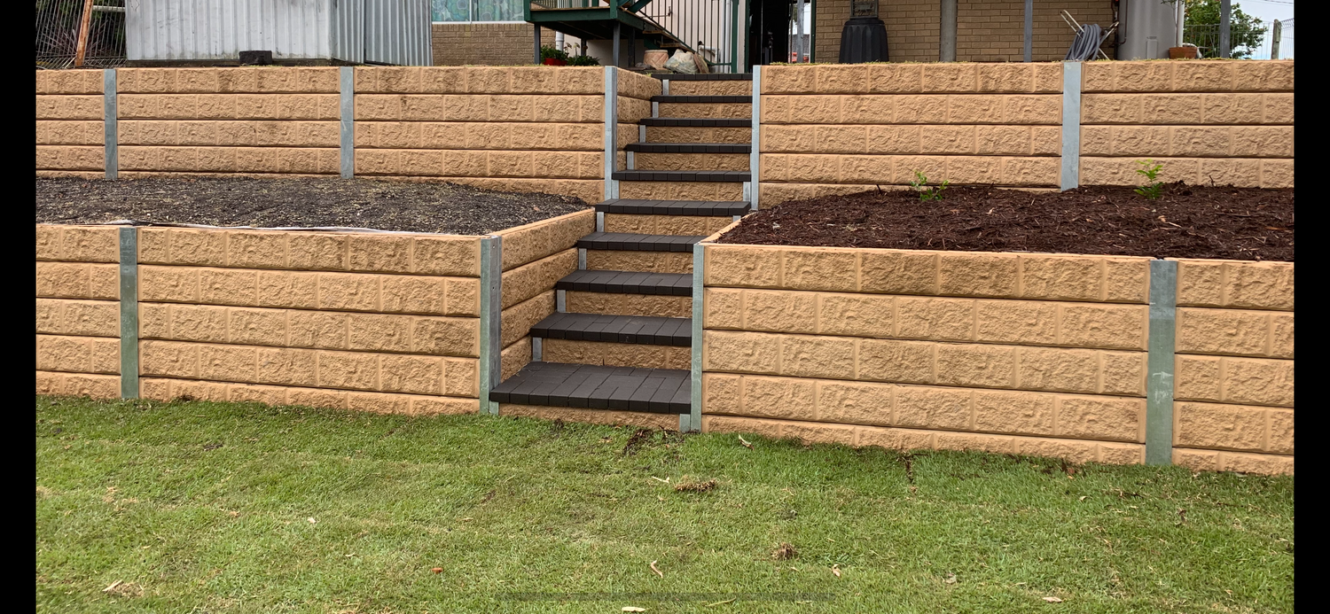 Completed retaining wall and landscaped residential yard